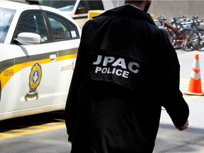 A police officer with UPAC on his jacket