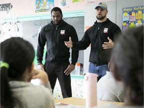 Alouettes players William Stanback, left, andJean-Gabriel Poulin talk to students at Hampstead Elementary School on Friday, January 25, 2019.