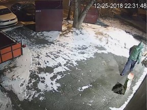 Screen grab of an arson suspect who set a fire in a bag behind a Richelieu St. business on Dec. 25, 2018 in St-Jean-sur-Richelieu.