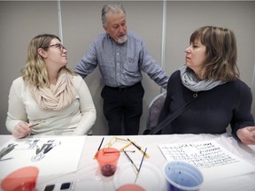 Karen Jones, right, and daughter Julia Jones listen to Fishel Goldig tell of how he survived the Holocaust, during an illustration workshop to mark International Holocaust Remembrance Day at the Montreal Holocaust Museum on Sunday. Participants drew illustrations based on Goldig’s harrowing story; Julia drew an image of Goldig’s family fleeing with only what they could carry, and her mother drew a breach in a ghetto wall.