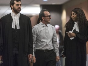 Michel Cadotte leaves the courtroom with his lawyers during a break at the Montreal courthouse on Monday.