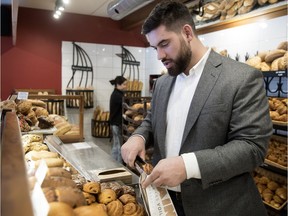 Kansas City Chiefs offensive-lineman Laurent Duvernay-Tardif serves some pastry to customers on Jan. 29, 2019, as he visits the Boulangerie Le Pain dans le Voiles on de Castelnau St. East in Montreal — one of three bakeries his family owns, with the other two on the South Shore.