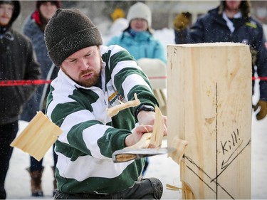 Kyle McKee from Fleming College in Lindsay, Ont., sends wood chips flying as he competes in the vertical chop during the 59th annual Woodsmen competition at the MacDonald Campus of McGill University  in Ste-Anne-de-Bellevue on Saturday Jan. 26, 2019.