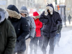 Pedestrians bundle up against the bitterly cold wind on René-Lévesque Blvd on Thursday.
