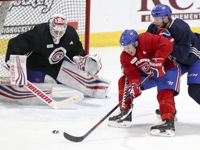 Canadiens' Brendan Gallagher protects the puck from defenceman Victor Mete in front of goalie Antti Niemi during practice Thursday in Brossard.