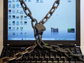 A photo illustration made December 14, 2012 in Montreal shows a computer in chains. Security experts warn about "ransomware," where computers or mobile phones are locked down by cyber thieves and money is demanded online.