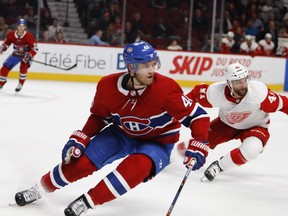 Montreal Canadiens winger Joel Armia and Detroit Red Wings centre Luke Glendening during action in Montreal on Oct. 15, 2018.