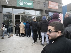 Customers wait in line at the L'Acadie Blvd. SQDC on the first day of legal marijuana in Canada on Oct. 17, 2018.