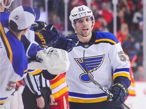 David Perron #57 (R) of the St Louis Blues celebrates after scoring against the Calgary Flames during an NHL game at Scotiabank Saddledome on December 22, 2018 in Calgary.