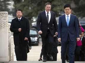 BEIJING, CHINA - JANUARY 09: Tesla CEO Elon Musk, center, arrives for a meeting with Chinese Premier Li Keqiang at the Zhongnanhai leadership compound on January 9, 2018 in Beijing, China.
