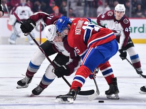 Matt Calvert of the Colorado Avalanche and Canadiens' Jesperi Kotkaniemi take a face-off at the Bell Centre on Saturday, Jan. 12, 2019.