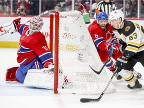 Canadiens goalie Carey Price slides across his crease as Boston Bruins Brad Marchand tries a wrap-around shot while being pursued by defenceman Shea Weber during NHL game at the Bell Centre in Montreal on Dec. 17, 2018.