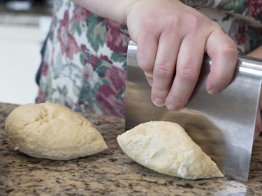 Diane Zalusky prepares her dough for varenyky. Rounds of homemade dough that has rested are quartered and each quarter is then rolled into a log shape and sliced into rounds. The rounds are in turn patted with flour, rolled out and then filled. (Allen McInnis / MONTREAL GAZETTE)
