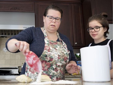 Diane Zalusky dusts the kitchen counter surface with flour before starting to roll out the dough for varenyky. She and her daughter, Eve Normand, make the plump hand-filled dumplings that are part of the family's traditional Ukrainian Christmas Eve meal. (Allen McInnis / MONTREAL GAZETTE)