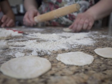 Small rounds of dough have been rolled out and will be filled with a mix of mashed russet potato and farmer's cheese as Diane Zalusky and her daughter, Eve Normand, make varenyky. (Allen McInnis / MONTREAL GAZETTE)