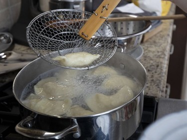 A varenyky is pulled from boiling water to test the doneness of the dough. (Allen McInnis / MONTREAL GAZETTE)