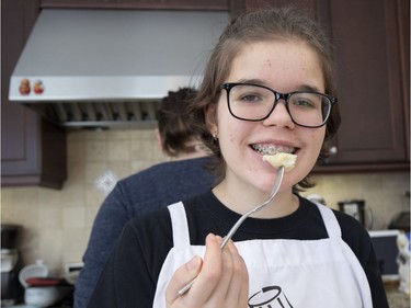 Eve Normand tastes the fruits of her labour for doneness. She and her mother, Diane Zalusky, are making varenyky, dumplings served as part of the traditional Ukrainian Christmas Eve meal on Jan. 6. (Allen McInnis / MONTREAL GAZETTE)