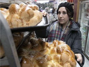 Jenn Brook, the cook at Auberge Shalom pour femmes, at the Kosher Quality bakery and market on Victoria Ave. on a Friday morning, picking up braided challah breads for the Friday night Sabbath meal at the shelter for women and children. Kosher Quality provides three challahs every Shabbat to Auberge Shalom, gratis.