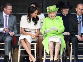Queen Elizabeth II laughs with Meghan, Duchess of Sussex during a ceremony to open the new Mersey Gateway Bridge on June 14, 2018 in the town of Widnes in Halton, Cheshire, England.