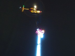 A helicopter hovers over a giant fairground ride after eight people got stuck high in the air in the Brittany city of Rennes late on December 31, 2018.