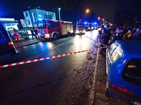 Police and firefighters stand in front of a place, where a fire that broke out in an escape room killed five teenage girls, in the northern Polish city of Koszalin on January 4, 2019. - Five teenage girls died and one man was seriously injured on January 4 when a fire broke out in a room where they were playing an escape game in the northern Polish city of Koszalin, officials said. Police and fire officials said they did not yet know what started the blaze in the escape room, which was reported in the early evening.