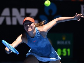 Russia's Maria Sharapova hits a return against Britain's Harriet Dart during their women's singles match on day one of the Australian Open tennis tournament in Melbourne on Monday, Jan. 14, 2019.
