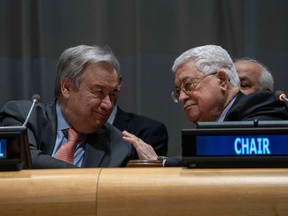 United Nations Secretary General Antonio Guterres (L) speaks with Palestinian president Mahmud Abbas during a meeting of the United Nations Group of 77 and China January 15, 2019 at the United Nations in New York. The event marked the state of Palestine taking over the chair of the G77 and China.