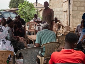 Relatives and friends of murdered Ghanian undercover reporter Ahmed Hussein Suale are seen during a mourning gathering in Accra, on January 17, 2019 - Family and friends gather to discuss the murder of Ghanian undercover reporter Ahmed Hussein Suale at a popular spot where he used to sit and drink with family and friends in Accra. Ghanaian police on January 17, 2019 opened an investigation after an undercover journalist who helped expose corruption in African football was shot dead.