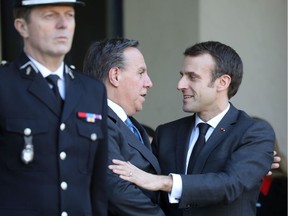 Quebec Premier François Legault (centre) greets French President Emmanuel Macron following a state lunch at the Elysee Palace Jan. 21, 2019, in Paris.