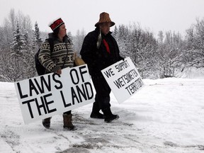 Todd Nelson and Christy Brown from the Nisga'a Nation arrive on Wednesday in support of the Unist'ot'en camp and Wet'suwet'en First Nation gather at a campfire off a logging road near Houston, B.C.