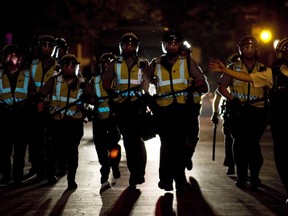 Police move in on protesters opposing Quebec student tuition fee hikes during a demonstration in Montreal, Sunday, May 20, 2012.