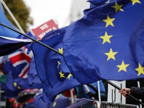 The EU and British flags wave at the demonstrations area near the parliament building in London, Wednesday, Jan. 16, 2019. British lawmakers overwhelmingly rejected Prime Minister Theresa May's divorce deal with the European Union on Tuesday, plunging the Brexit process into chaos and triggering a no-confidence vote that could topple her government.