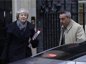 Prime Minister Theresa May leaves 10 Downing Street in London, Wednesday, Jan. 16, 2019. British lawmakers overwhelmingly rejected Prime Minister Theresa May's divorce deal with the European Union on Tuesday, plunging the Brexit process into chaos and triggering a no-confidence vote that could topple her government.