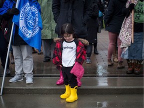 Michiko Lee, 3, wears a t-shirt with the word feminist on it during a women's march in Vancouver, Jan. 20, 2018.