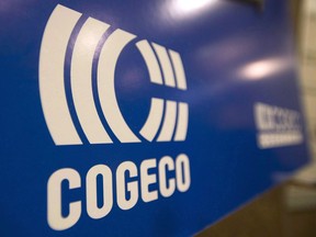 A Cogeco sign hangs at the company's annual general meeting in Montreal, Tuesday, January 14, 2014. Cogeco Inc. says an acquisition by its cable and internet segment pushed up first-quarter revenue, but profit was down due to higher costs associated with integrating and restructuring the business.