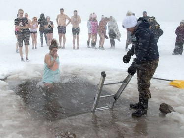 Revellers brave stormy conditions as they participate in the annual New Year's polar bear dip in Charlottetown harbour on Tuesday, Jan. 1, 2019.