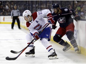 Canadiens' Brendan Gallagher, left, controls the puck against Columbus Blue Jackets' Ryan Murray in Columbus, Ohio, on Friday, Jan. 18, 2019.