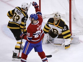 Montreal Canadiens defenseman Jeff Petry (26) raises his fist after beating Boston Bruins goaltender Tuukka Rask (40) on the game-winning goal during an overtime period of an NHL hockey game in Boston, Monday, Jan. 14, 2019. The Canadiens defeated the Bruins 3-2. At left is Boston Bruins defenseman Charlie McAvoy (73).