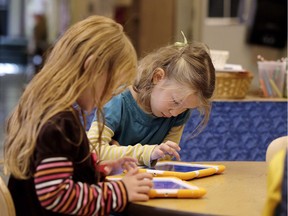 Children work on iPads.