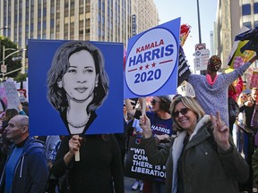 In this Saturday, Jan. 19, 2019, photo demonstrators hold posters of Kamala Harris 2020 during the Women's March in Los Angeles. Harris, a first-term senator and former California attorney general known for her rigorous questioning of President Donald Trump's nominees, entered the Democratic presidential race on Monday, Jan. 21.(AP Photo/Damian Dovarganes) ORG XMIT: CADD701