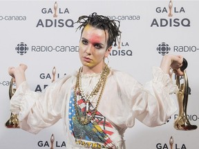 Hubert Lenoir holds up his trophies at the Gala Adisq awards ceremony in Montreal in October 2018.