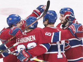 Montreal Canadiens' Brett Kulak (17) celebrates with teammates Phillip Danault, left, Victor Mete, right, and Artturi Lehkonen (62) after scoring against Colorado Avalanche during third period in Montreal on Jan. 12, 2019.
