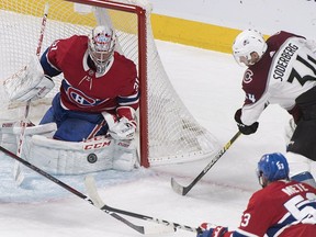 Montreal Canadiens goaltender Carey Price makes a save against Colorado Avalanche's Carl Soderberg as Canadiens' Victor Mete defends during third period in Montreal on Jan. 12, 2019.