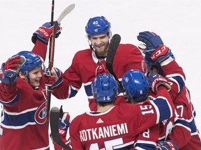 Canadiens defence man Jordie Benn (8) celebrates with teammates after scoring against the Vancouver Canucks during first period of NHL game at the Bell Centre in Montreal on Thursday, Jan. 3, 2019.