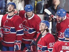 Jonathan Drouin (92) looks up at the replay with Kenny Agostino (47), Michael Chaput (43), Nicolas Deslauriers (20) and Max Domi (13) after scoring during second period action against the Canucks on Thursday.