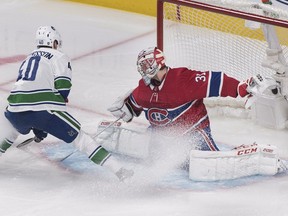 Canadiens goalie Carey Price thwarts Canucks super rookie Elias Pettersson during first period Thursday night at the Bell Centre.