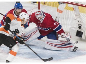 Philadelphia Flyers' Oskar Lindblom moves in on Canadiens goaltender Antti Niemi as Canadiens' Jeff Petry defends in Montreal on Saturday, Jan. 19, 2019.