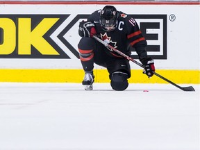 Canada's Maxime Comtois kneels on the ice after losing to Finland during overtime quarter-final IIHF world junior hockey championship action in Vancouver on Wednesday, Jan. 2, 2019.