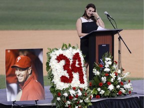 Brandy Halladay, wife of late pitcher Roy Halladay, wipes her eyes while talking about her husband during an event honoring his life, at Spectrum Field in Clearwater, Fla., on Nov. 14, 2017.