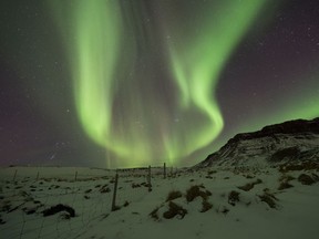 The Northern Lights, or aurora borealis, over Bifrost, Western Iceland.